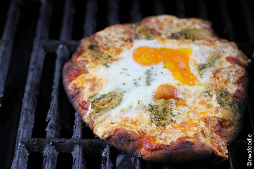 Grilled chicken pesto pizza with fried egg on the grill (c)nwafoodie