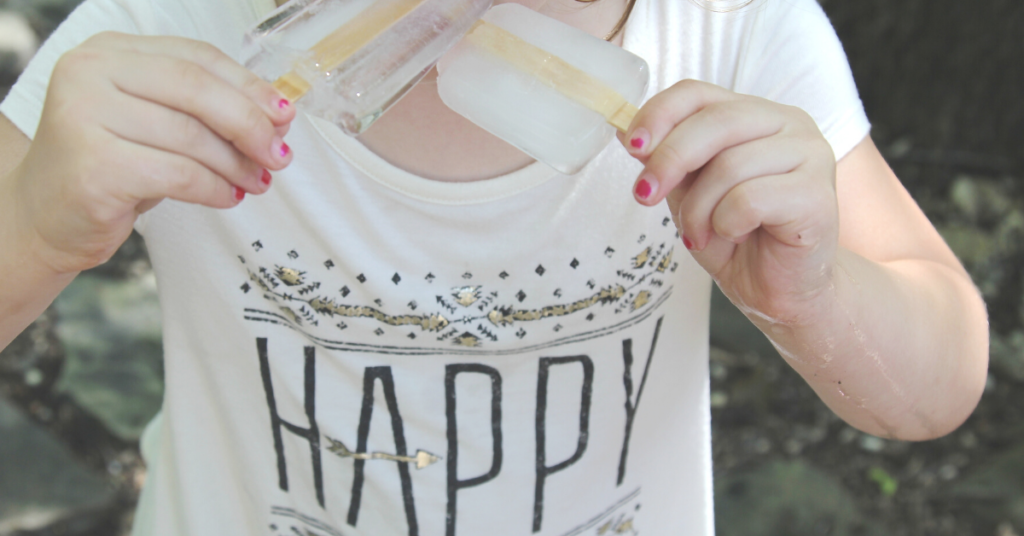 girl eating popsicles who is happy