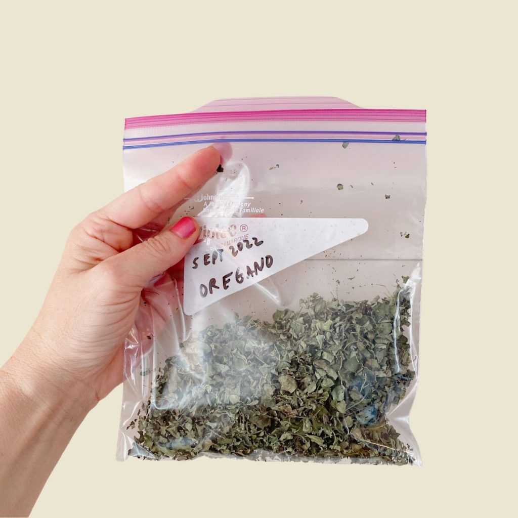 graphic of hand holding a bag of dried oregano