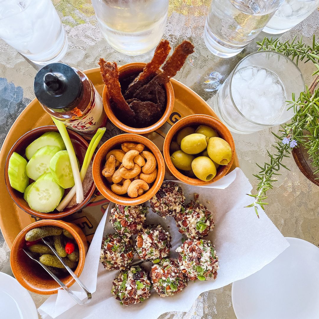 table with snacks on a tray and drinks