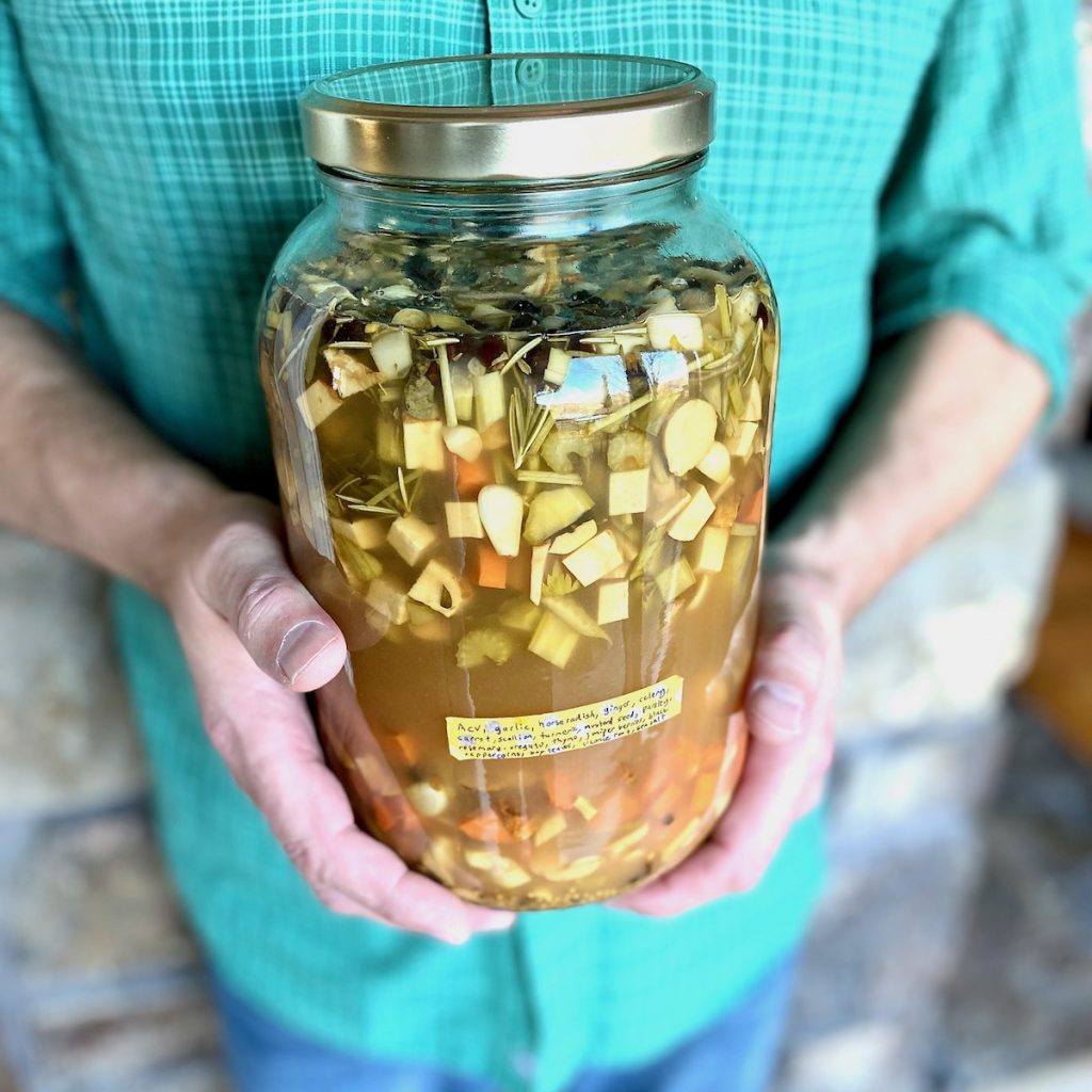 man holding jar of fire tonic