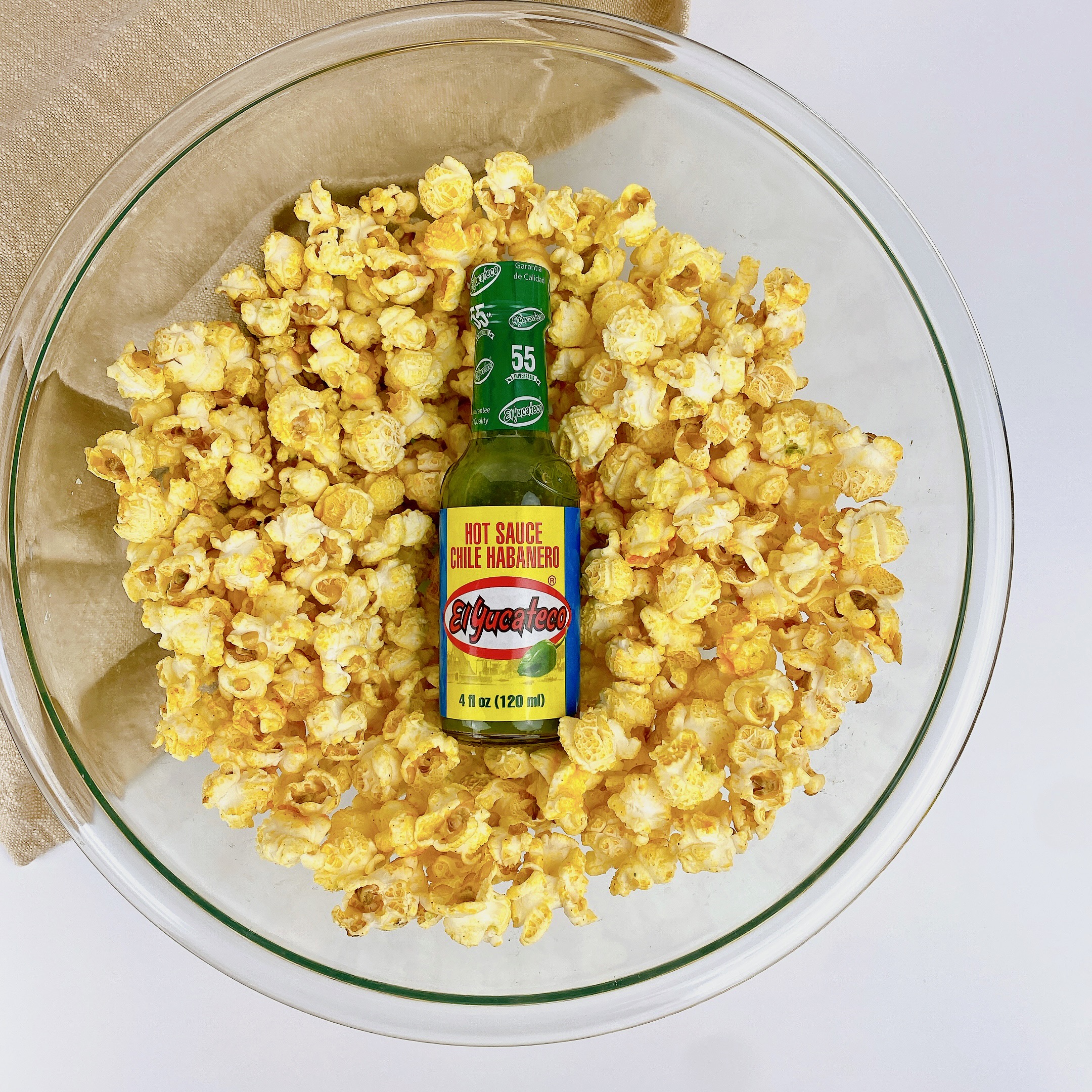 El Yucateco bottle in a bowl of popcorn