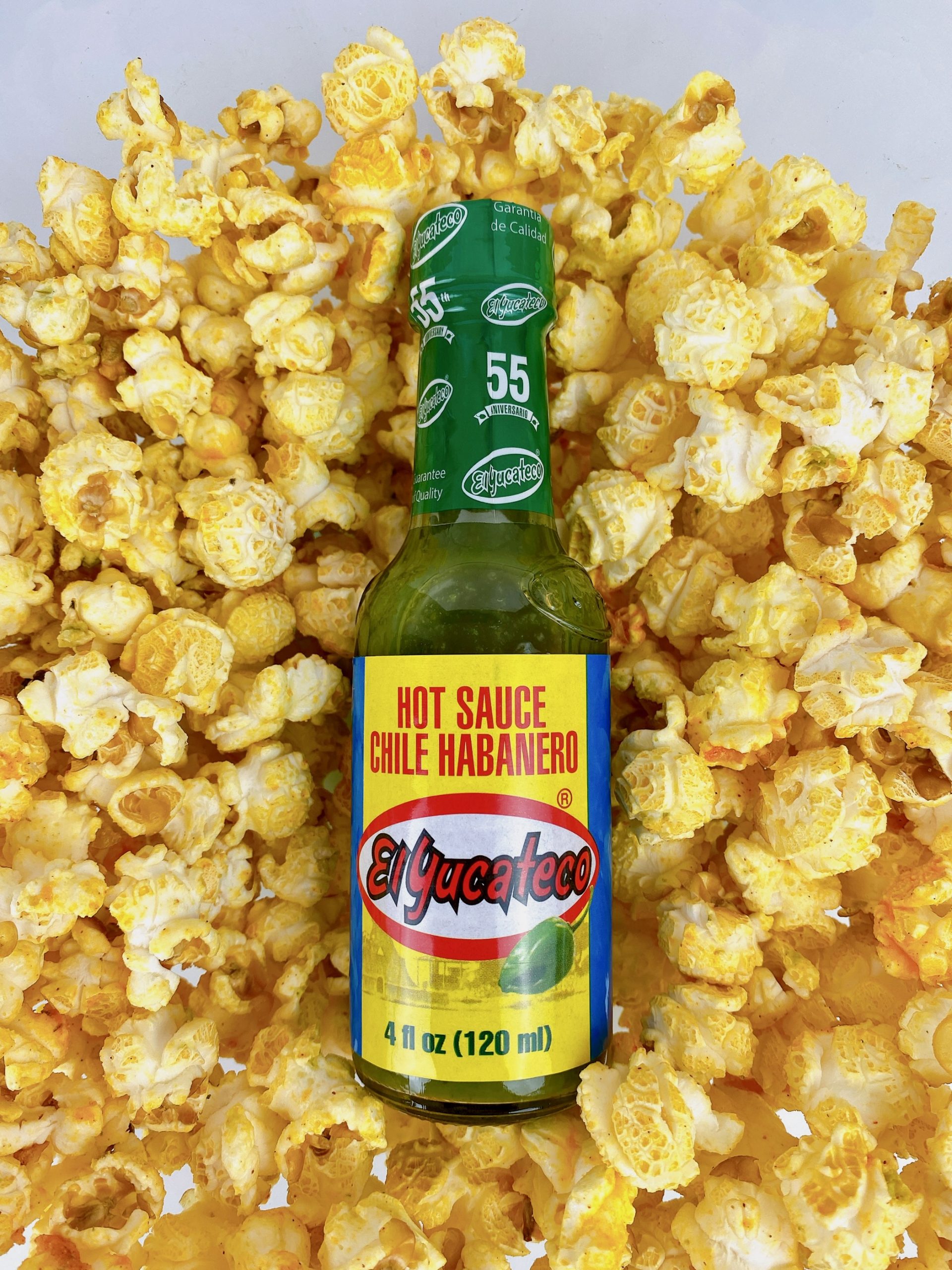 El Yucateco bottle sitting in popcorn